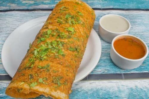 Crisp golden butter masala dosa served with coconut chutney and sambar
